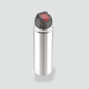 Silver stainless steel insulated thermos flask with black and red lid on gray background